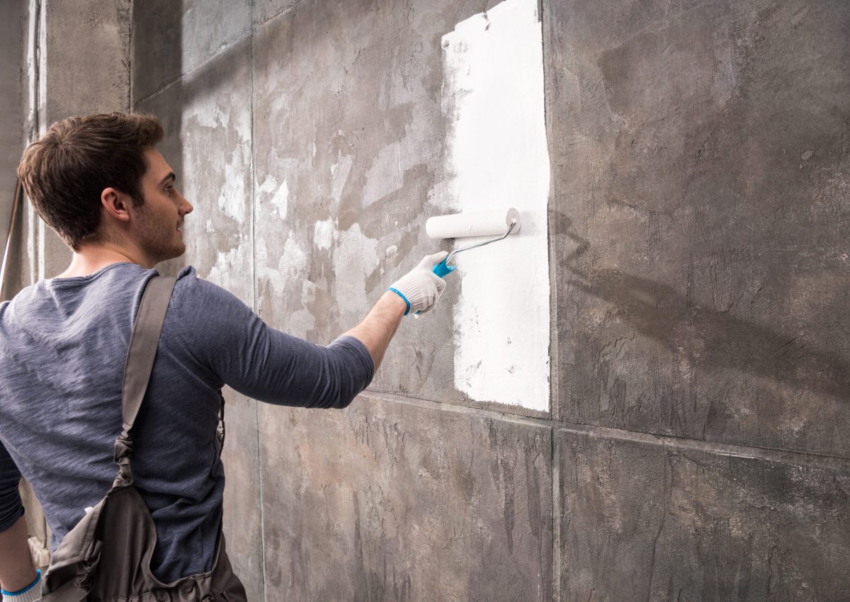 young man painting wall, renovation home concept